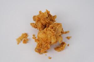 Golden brown fried chicken on white background. Fried chicken isolated over white. Fried chicken isolated on white background. Crispy fried chicken pieces in mid-air with crumbs scattering isolated photo