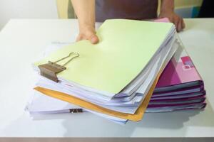 Man manager are filing account documents in front photo