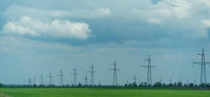 High voltage towers with sky background. Power line support with wires for electricity transmission. High voltage grid tower with wire cable at distribution station. Energy industry, energy saving photo