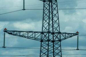 High voltage towers with sky background. Power line support with wires for electricity transmission. High voltage grid tower with wire cable at distribution station. Energy industry, energy saving photo