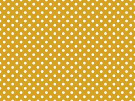 texturised white color polka dots over goldenrod brown backgroun photo