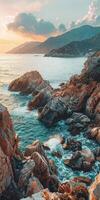 Rocky coastline with mountains at sunset near the ocean photo