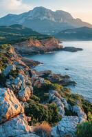 Rocky coastline and mountains at sunset in a serene landscape photo
