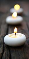 Calming Zen candles and smooth stones arranged on a wooden surface photo