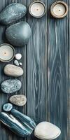 Zen arrangement of candles and smooth stones on wooden table photo