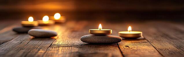 Calm zen setting with candles and smooth stones at dusk photo