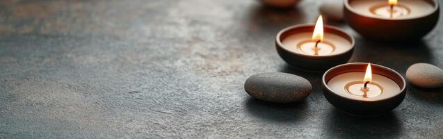 Soothing zen background with lit candles and smooth stones photo