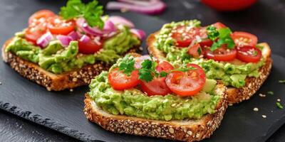 Avocado hummus toast topped with fresh tomatoes and herbs for breakfast photo