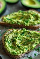 Fresh avocado hummus toast topped with herbs on whole grain bread photo