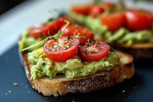 Avocado hummus toast topped with cherry tomatoes and herbs on a table photo