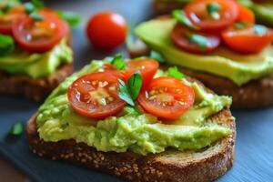 Delicious avocado hummus toast topped with cherry tomatoes and herbs photo
