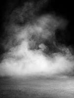 Smoke swirling across a dark background in low light conditions photo