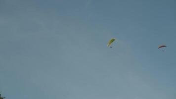 A powered parachute at Vang Vieng, Laos during sunset with a backdrop of karst mountains video