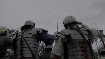 Medieval warriors in armor ready for battle, showing determination and strength in a reenactment video