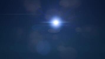 Bright light source with lens flare effects on dark blue background. Suitable for use in technology or spacethemed designs. Vibrant and dynamic video