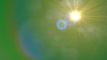 Bright sun with lens flare on green background. Perfect for summer, nature, energy, and environment related concepts in designs and projects video