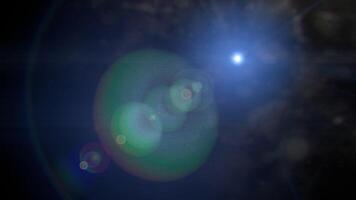 Bright white light with lens flares in a dark blue background. Suitable for abstract backgrounds, technology concepts, science fiction themes video