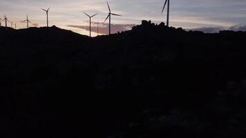 Aerial footage wind mills turbine rotating by the wind and generating renewable green energy. video