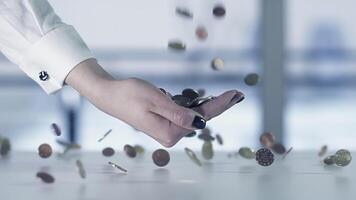 The act of hand tossing coins represents a financial idea in terms of wealth and prosperity video