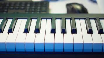 Electronic piano keyboard with mixing console at home studio used for producing tunes and soundtracks, acoustical engineering devices for music production. Empty desk with synthesizer device. video