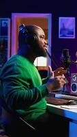 Vertical Artist producer singing a new song to record on microphone, preparing to edit music in post production. Musician expert applying mixing and mastering techniques on his audio recorded files. Camera B. video