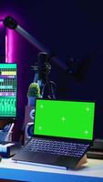 Vertical Professional artist operating on daw software in home studio, using a green screen layout next to him. Producer editing his audio recordings by applying mixing and mastering techniques. Camera B. video