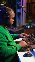 Vertical Skilled music producer composing new soundtracks on console and daw software, working with stereo gear in home studio. Young artist engineer uses pre amp knobs, signal processing. Camera B. video