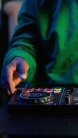 Vertical Skilled audio engineer teaching online mixing tunes lessons by using smartphone on tripod to record himself in home studio. Producer hosting a master class with soundboard console gear. Camera A. video