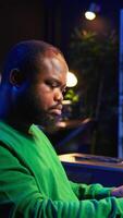Vertical Sound engineer pressing keys of electronic synthesizer and composing new song, adjusting volume levels on pre amp knobs. Composer producing music on piano midi controller, mixing tunes. Camera B. video