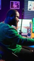 Vertical Artist playing piano electronic keyboard and recording new sounds, producing new midi controller notes in his home studio. Audio producer working with digital audio workstation software. Camera B. video