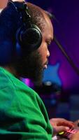 Vertical Skilled music producer composing new soundtracks on console and daw software, working with stereo gear in home studio. Young artist engineer uses pre amp knobs, signal processing. Camera A. video