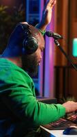 Vertical Audio engineer producing new music on mixing console in home studio, working with sound effects and pre amp knobs. Skilled producer creating songs and adjusting volume levels. Close up. Camera A. video