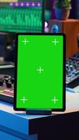 Vertical Composer editing his audio files and recordings on daw software, sitting next to a green screen display. Skilled sound technician uses mixing and mastering gear to produce new material. Camera A. video