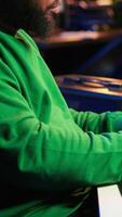 Vertical Songwriter mixing and mastering tracks on stereo console, playing electronic keyboard in home studio. Artist oversees audio performances to create melody, producing tunes with piano keys. Camera A. video