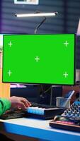 Vertical Artist plays midi controller synthesizer next to green screen layout, working on producing new music with his audio musical instruments in home studio. Musician using isolated copy space. Camera A. video