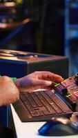Vertical Talented musician creating new soundtracks on mixing console, operating on audio equipment in home studio. Sound technician twisting knobs to edit volume levels on his melody. Camera A. video
