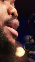 Vertical Skilled composer producing a new melody with lyrics and piano keys, recording audio files to edit them with mixing console. Young talented artist producer creating soundtracks. Camera A. video
