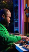 Vertical Artist playing electronic piano keyboard notes and recording audio files to use mix and master techniques, editing recordings to edit sound effects. Musician operating on synthesizer gear. Camera A. video