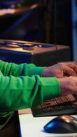Vertical Music composer plays electronic keyboard piano keys and recording new tracks, creating audio recordings before launching music. Artist producer uses synthesizer, post production. Camera A. video