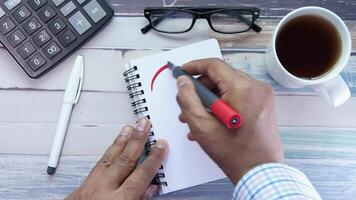 high angle view of hand drawing question mark on paper on office desk video