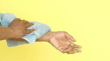 man drying his hands in a white towel, video