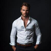 Confident Man in White Shirt Posing Against a Dark Background photo