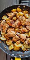 Savory Pan-Cooked Chicken and Potatoes With Herbs and Spices photo