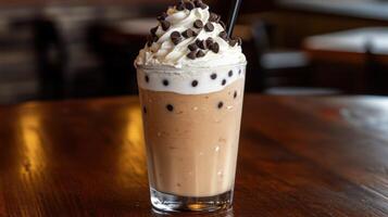 Creamy ice cream drink topped with whipped cream and chocolate chips photo