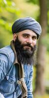 Muslim Man With Beautiful Beard Posing Outdoors in Nature on a Sunny Day photo