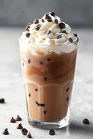 Creamy ice cream drink topped with whipped cream and chocolate chips photo