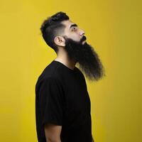 Muslim Man With a Big Beard Posing Against a Yellow Background photo