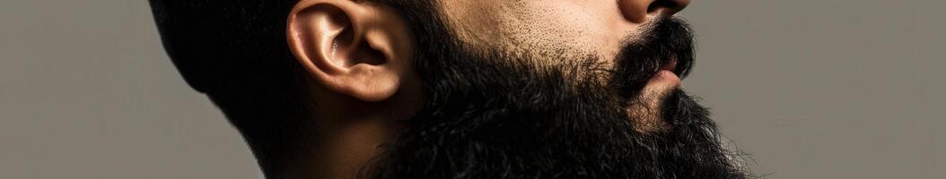 Muslim Man With a Beautiful Beard Posing Against a Neutral Background photo