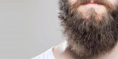 Muslim Man With Big Beard Posing Against Neutral Background photo