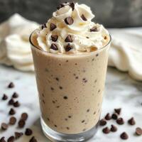 Delicious ice cream drink topped with whipped cream and chocolate chips photo